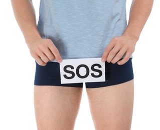 Man holding SOS sign on white background, closeup. Urology problems