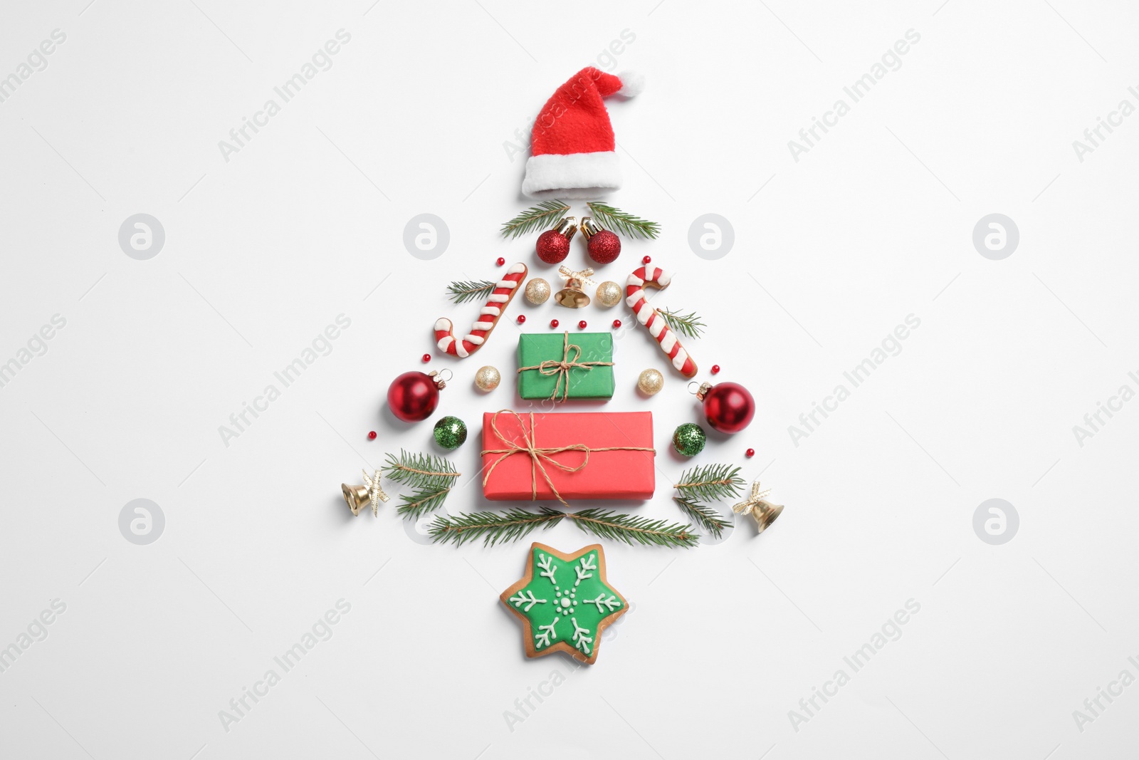 Photo of Christmas tree silhouette of fir branches and festive decoration on white background, top view