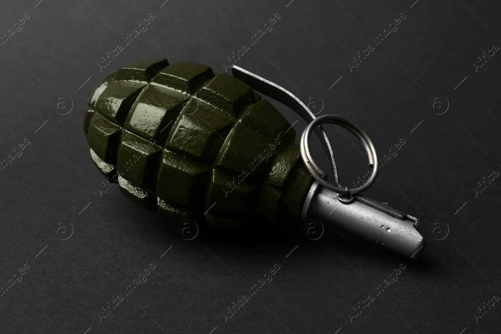 Photo of Hand grenade on black background, closeup. Explosive weapon