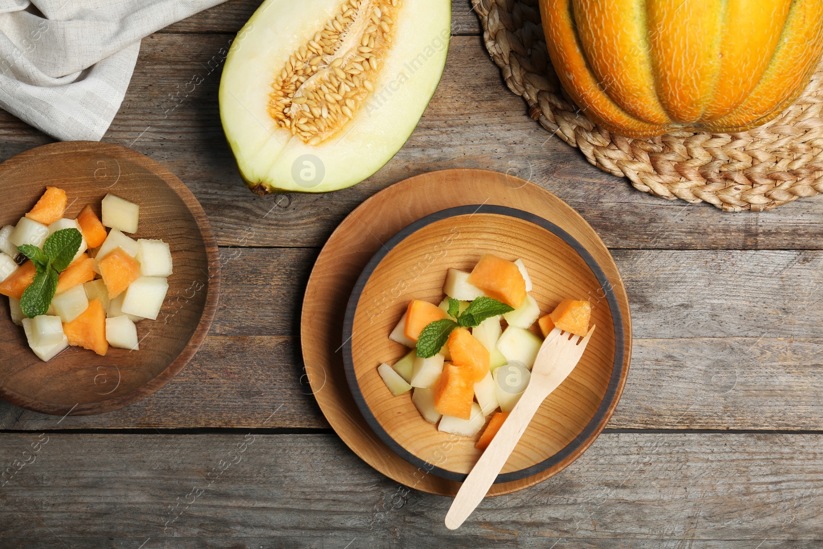 Photo of Salad with assorted melons on wooden background, top view
