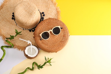 Photo of Flat lay composition with bamboo bag, beach items and space for text on color background