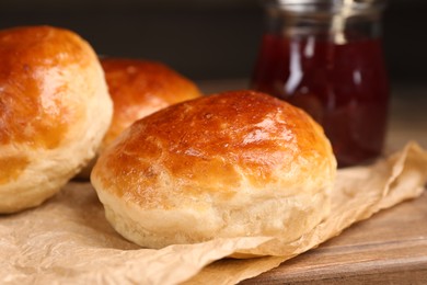 Tasty scones prepared on soda water and jam on wooden board, closeup