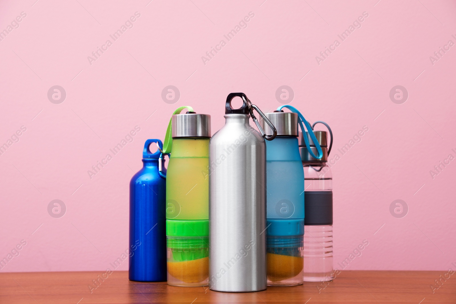 Photo of Different water bottles for sports on color background