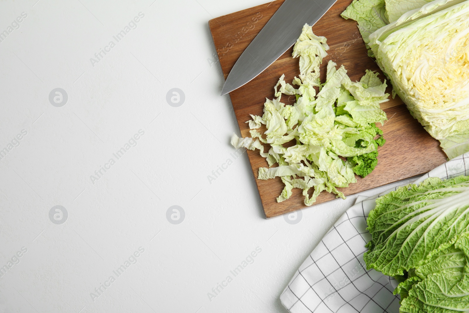 Photo of Cut Chinese cabbage on white table, flat lay. Space for text
