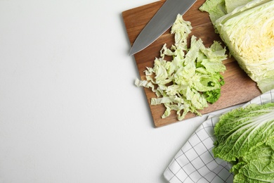 Cut Chinese cabbage on white table, flat lay. Space for text