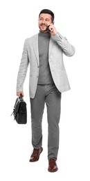 Photo of Handsome bearded businessman with briefcase talking on smartphone against white background