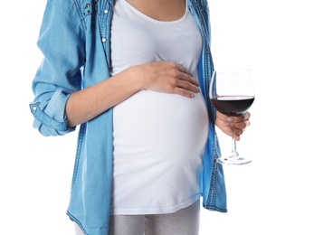 Photo of Future mother with glass of wine on white background, closeup. Alcohol abuse during pregnancy