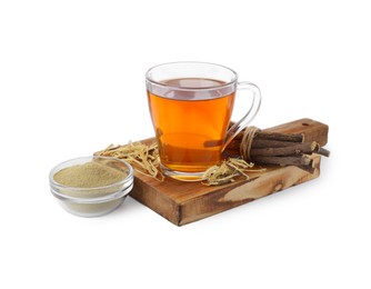 Photo of Aromatic licorice tea in cup, dried sticks of licorice root and powder isolated on white