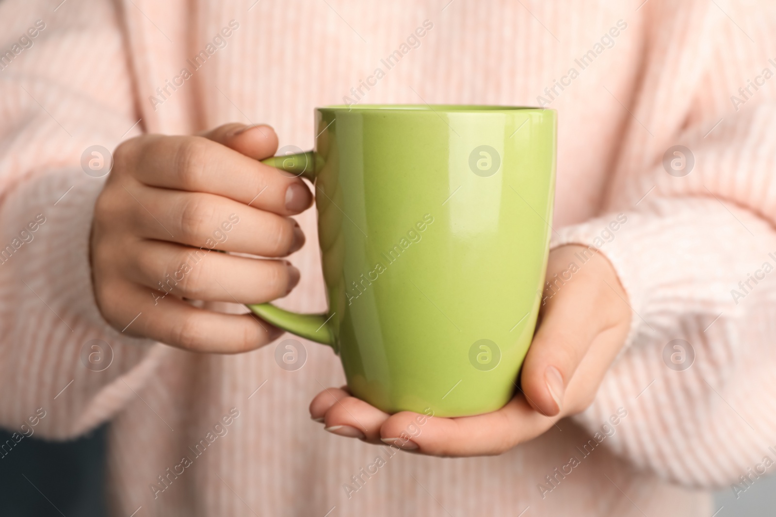 Photo of Woman holding mug of hot drink, closeup. Coffee Break