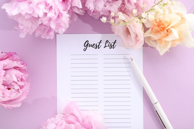 Guest list, pen and beautiful flowers on violet background, flat lay. Space for text