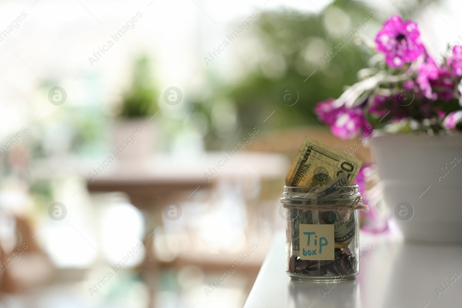 Photo of Glass jar with tips on table indoors. Space for text