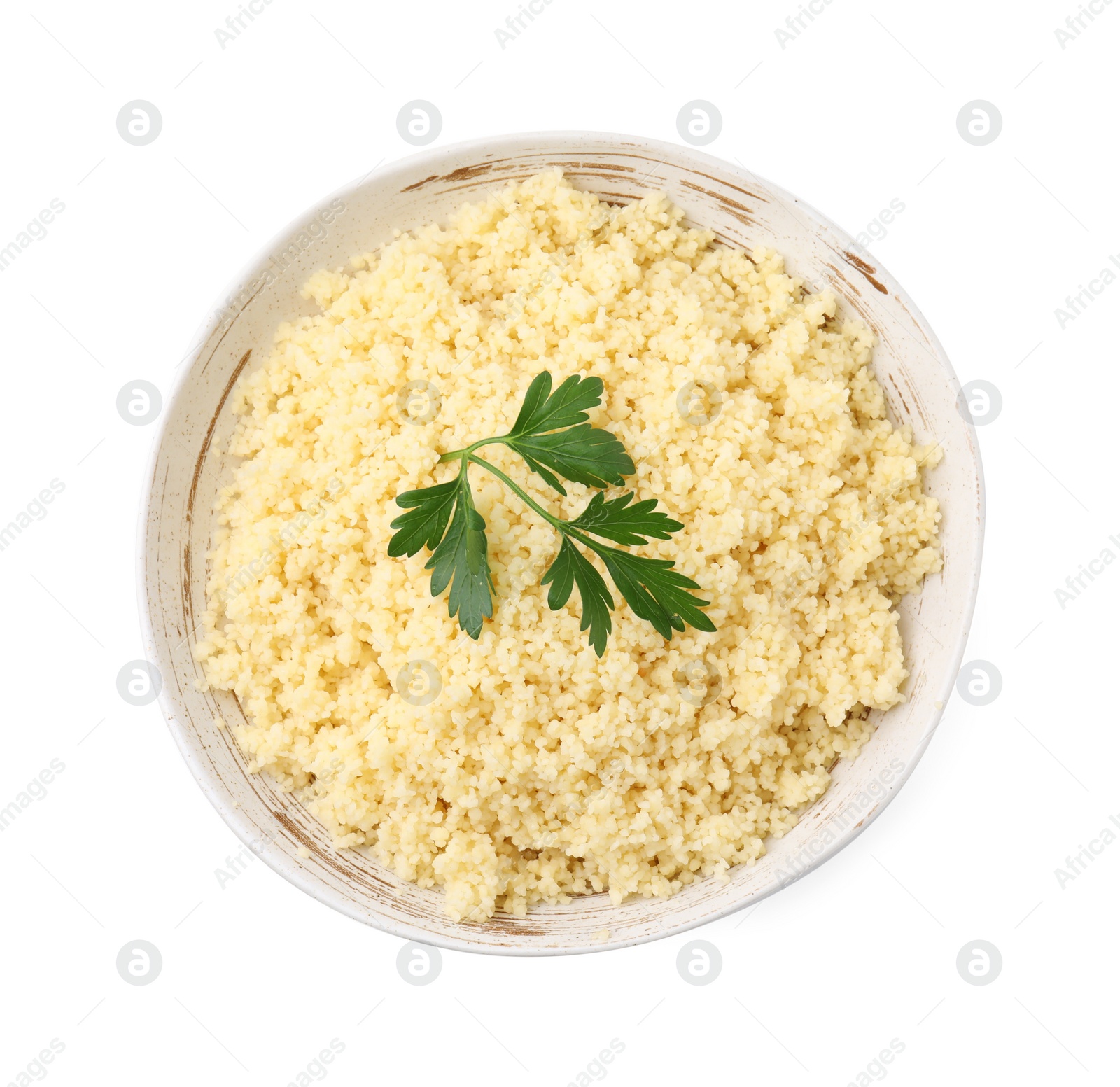Photo of Tasty couscous and fresh parsley in bowl isolated on white, top view