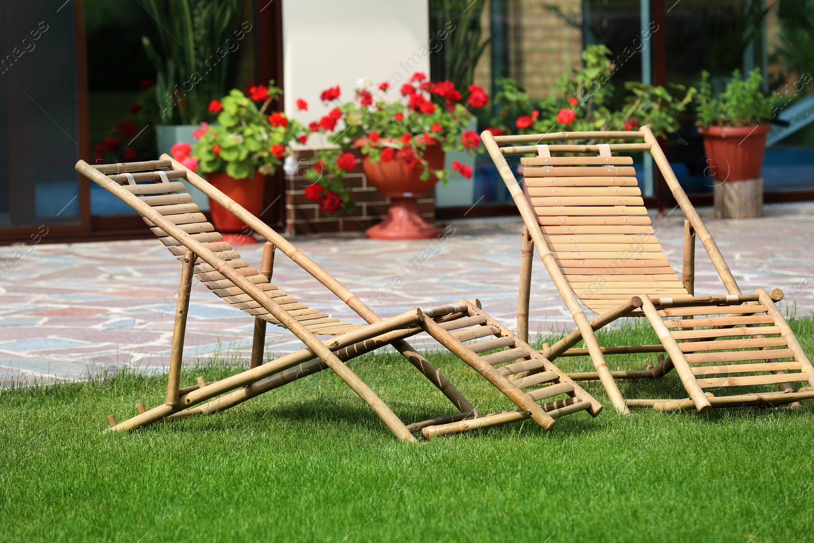 Photo of Wooden deck chairs in beautiful garden on sunny day