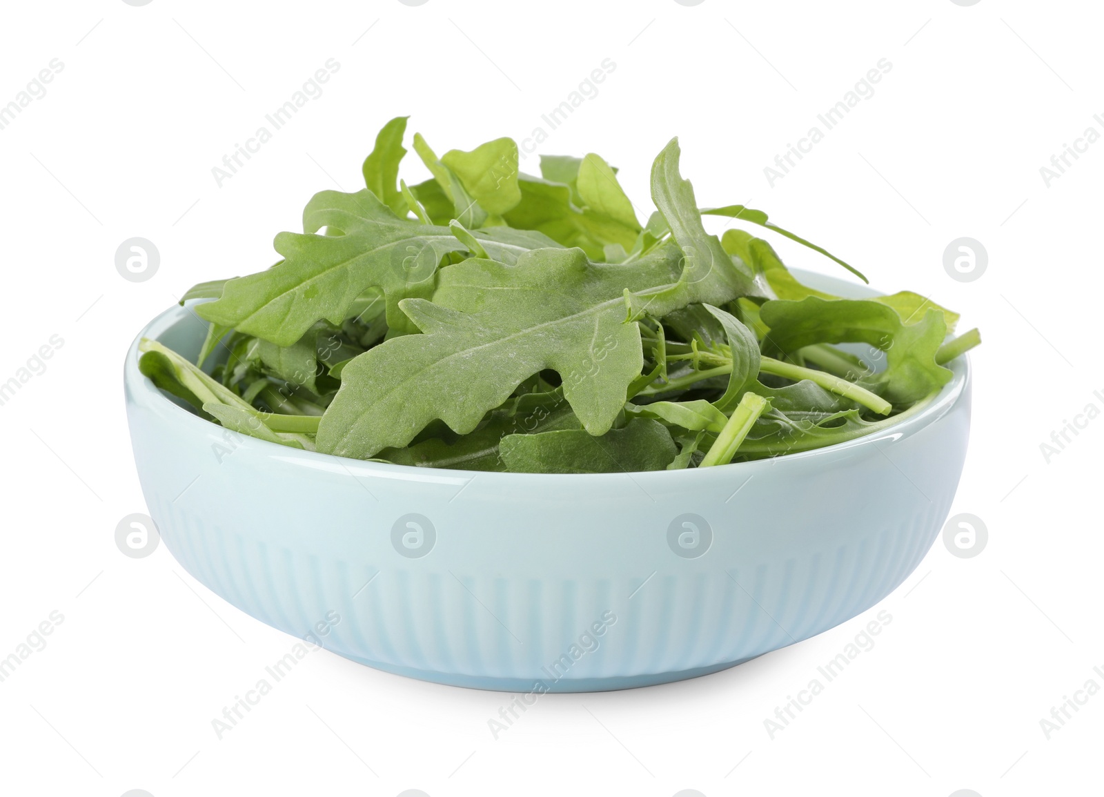 Photo of Delicious fresh arugula in light blue bowl isolated on white