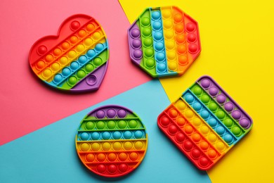 Rainbow pop it fidget toys on color background, flat lay