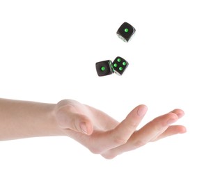 Photo of Woman throwing game dices on white background, closeup