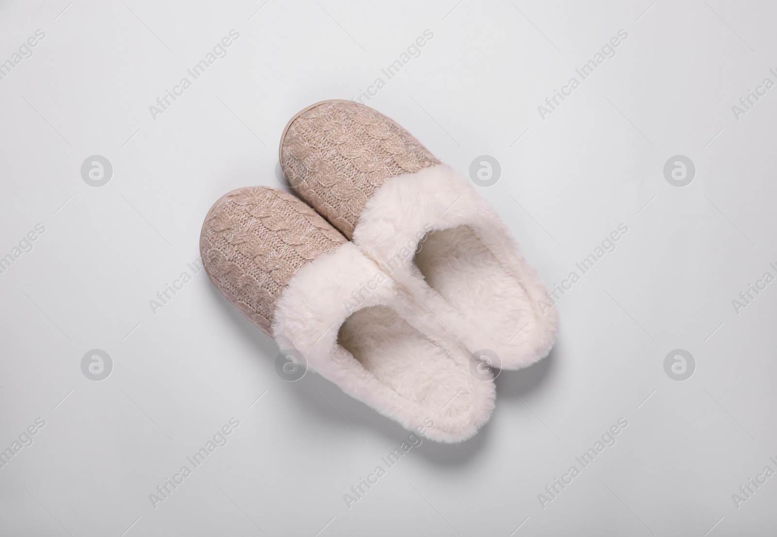 Photo of Pair of beautiful soft slippers on white background, top view