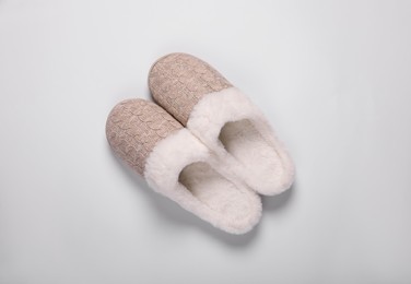 Photo of Pair of beautiful soft slippers on white background, top view