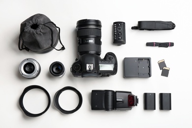 Flat lay composition with photographer's equipment and accessories on white background