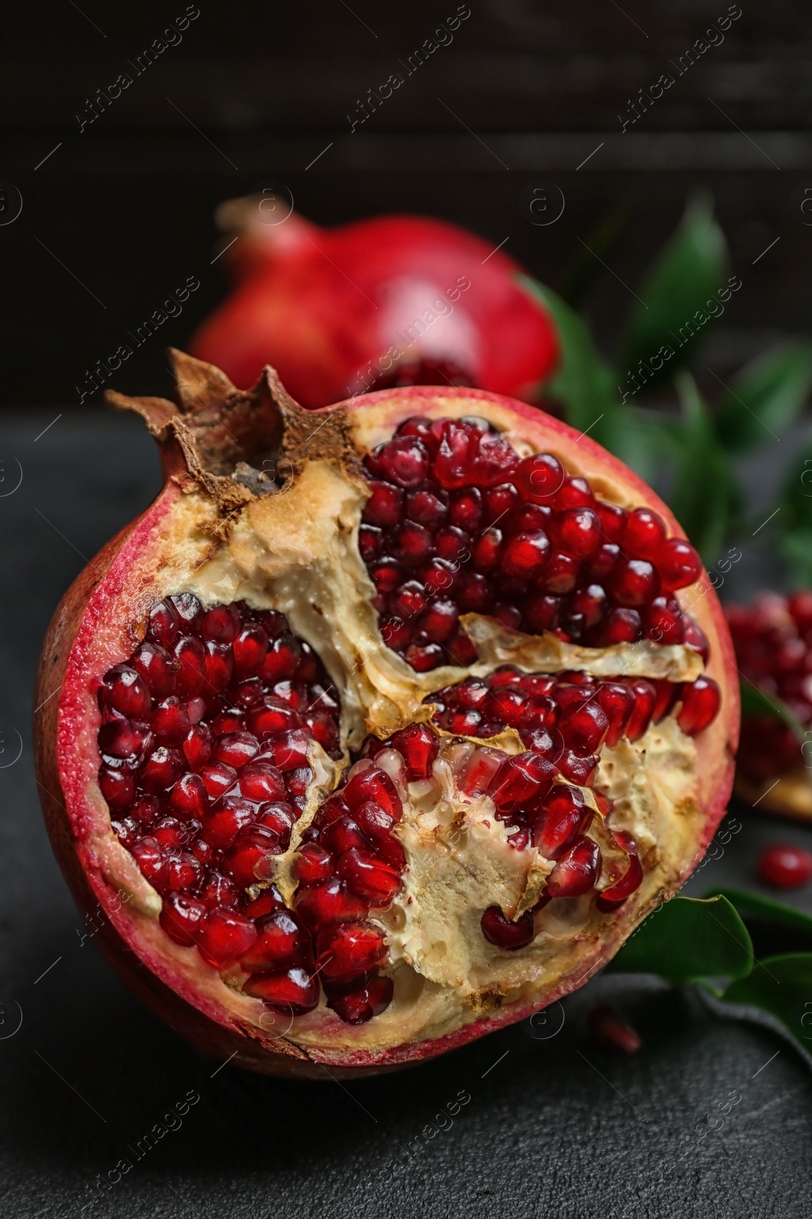 Photo of Fresh yummy pomegranate on dark table