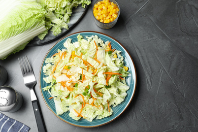 Fresh cabbage salad with carrot served on grey table, flat lay