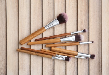 Makeup brushes on wooden background