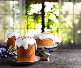 Traditional Easter cakes on grey table indoors. Space for text