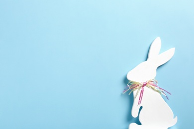 Photo of Easter bunny figure on color background, top view. Space for text