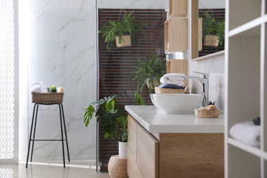 Photo of Counter with vessel sink in stylish bathroom interior. Idea for design