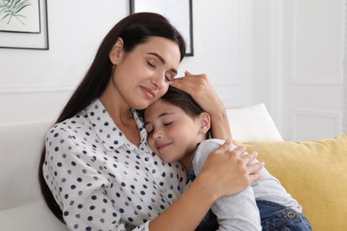 Happy mother and daughter hugging at home. Single parenting