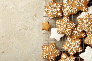 Photo of Tasty Christmas cookies with icing on light table, top view. Space for text