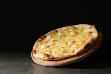 Photo of Hot cheese pizza Margherita on table against dark background. Space for text