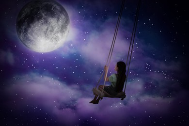 Image of Sleepwalking condition. Girl on swing in night sky with full moon