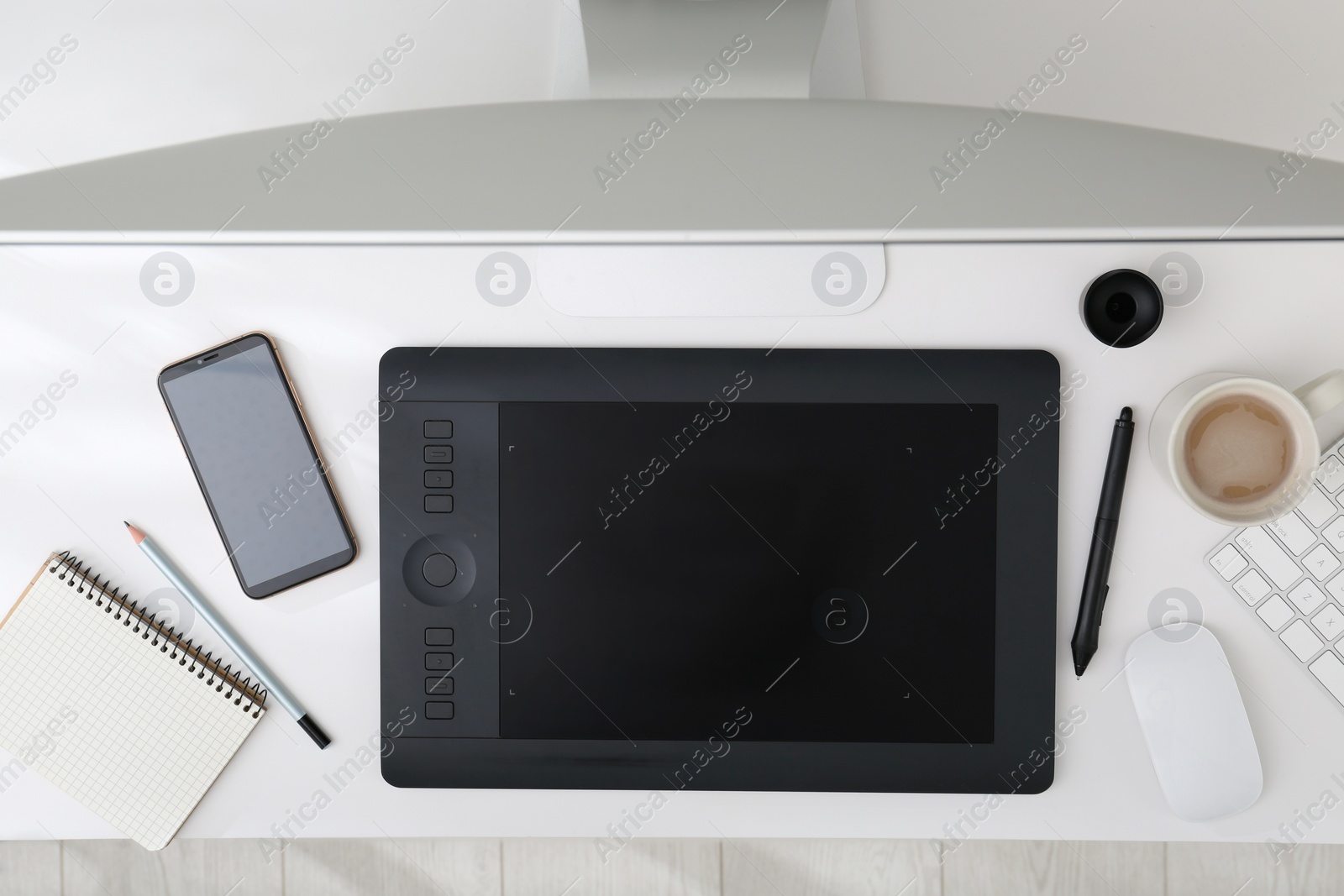 Photo of Flat lay composition with graphic tablet and smartphone on white table, top view. Retoucher's workplace