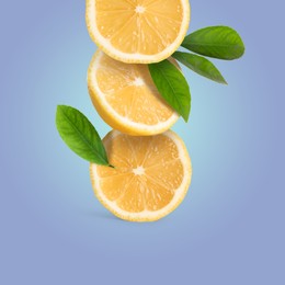 Image of Stack of cut fresh lemons with green leaves on light slate blue background