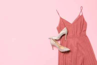 Photo of Stylish coral dress and shoes on pink background, flat lay. Space for text