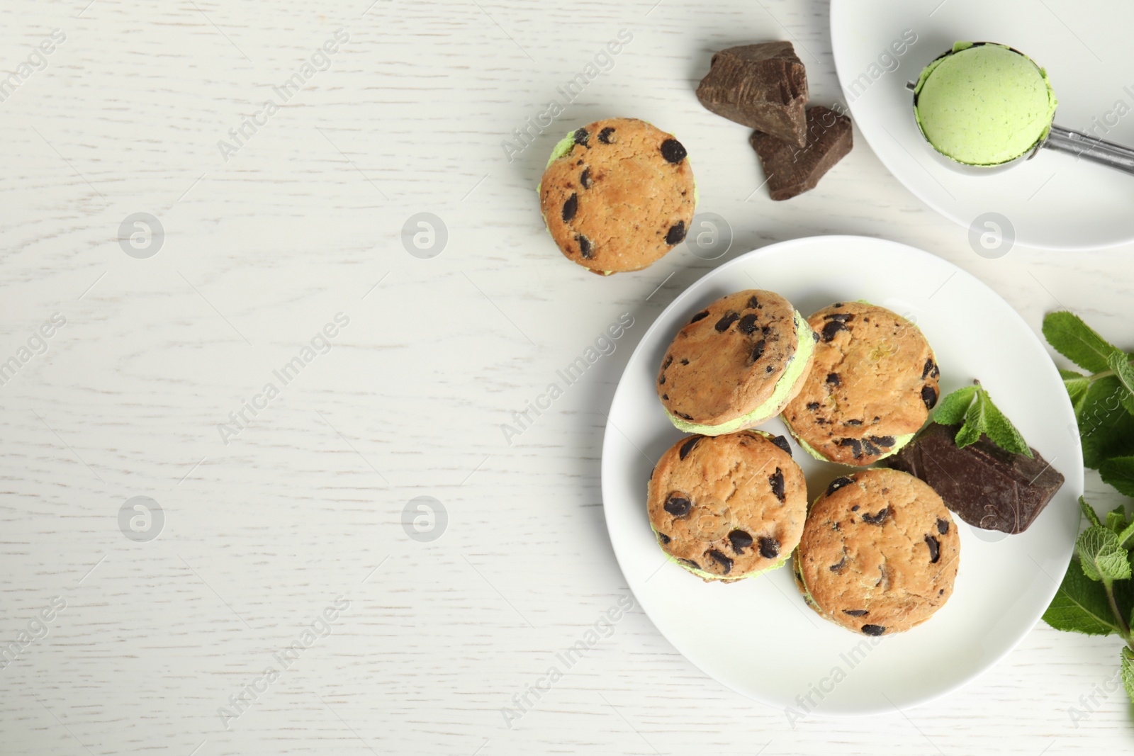 Photo of Sweet delicious ice cream cookie sandwiches served on table, flat lay. Space for text