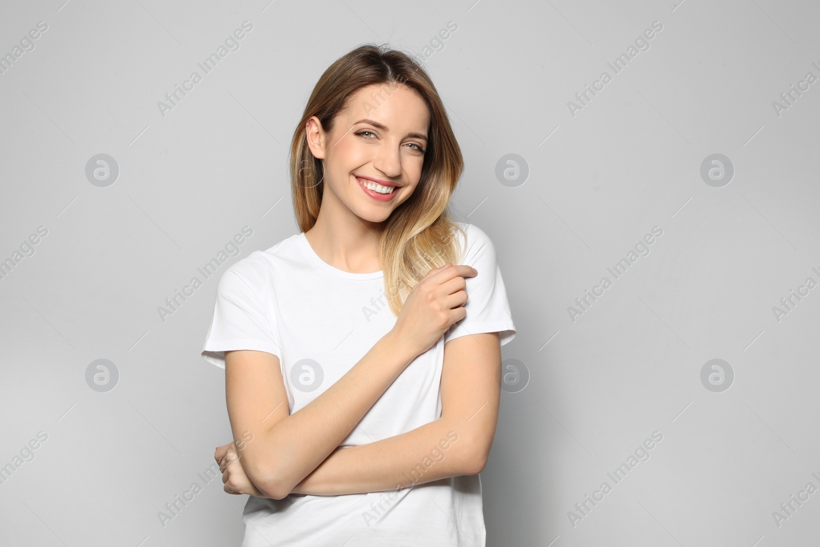 Photo of Portrait of young woman with beautiful face on grey background