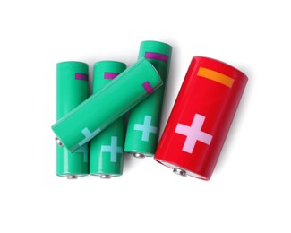 Photo of New AA and C size batteries isolated on white, top view