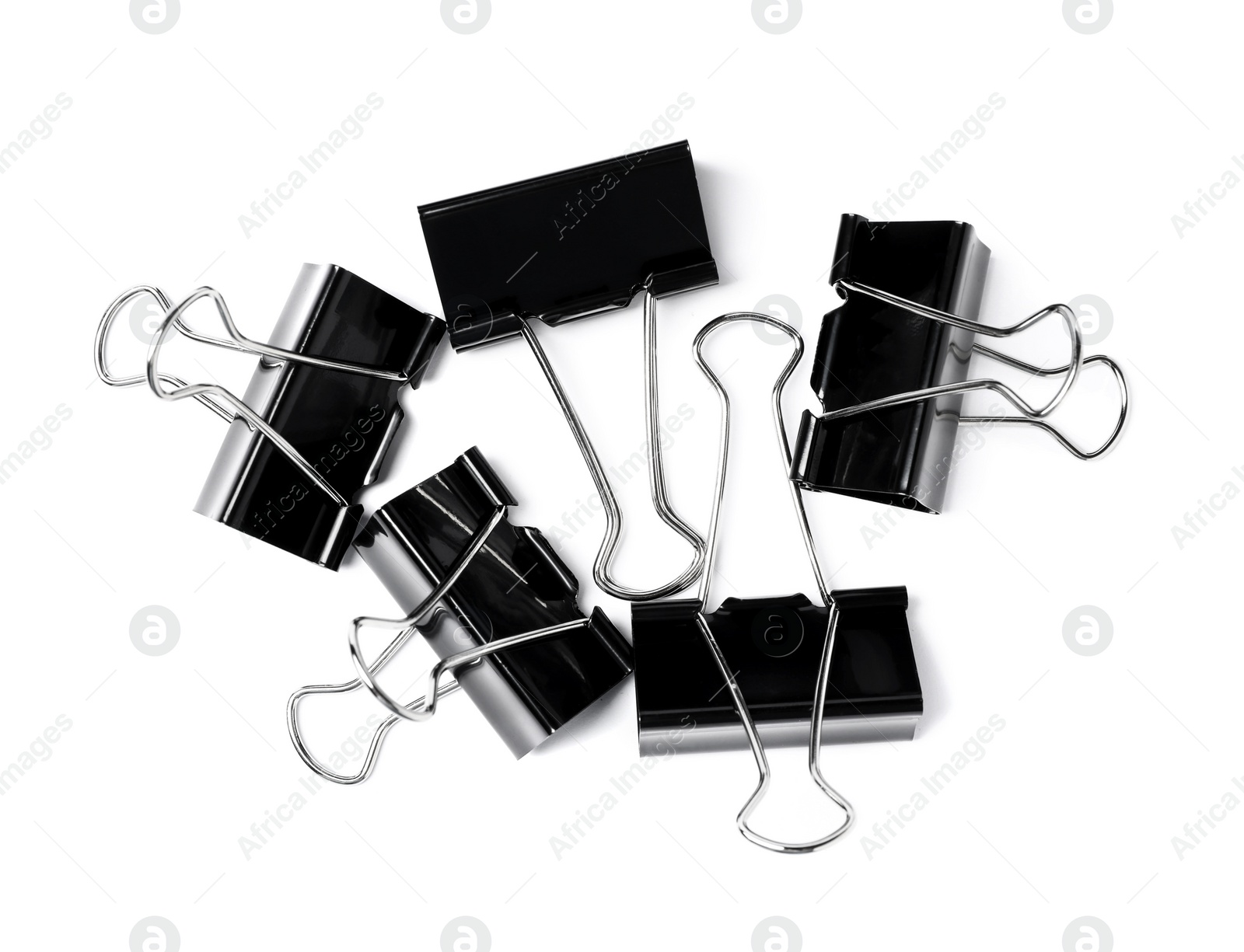 Photo of Black binder clips on white background, top view