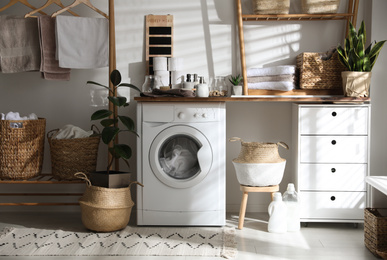 Photo of Stylish bathroom interior with modern washing machine