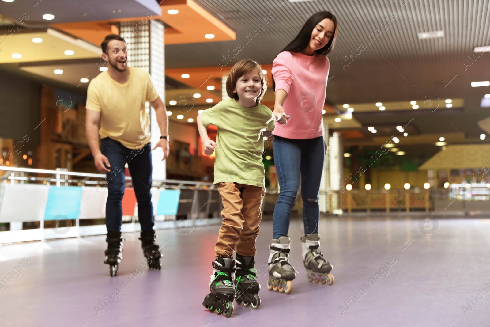 Photo of Happy family spending time at roller skating rink