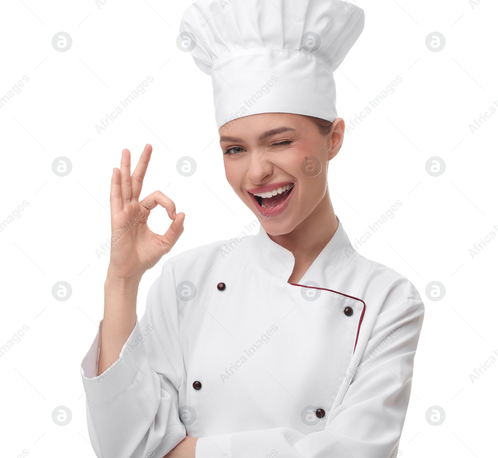 Photo of Happy woman chef in uniform showing OK gesture on white background