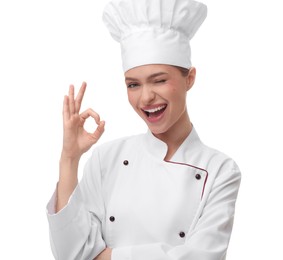 Happy woman chef in uniform showing OK gesture on white background