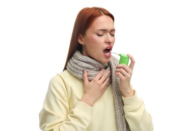 Photo of Young woman with scarf using throat spray on white background