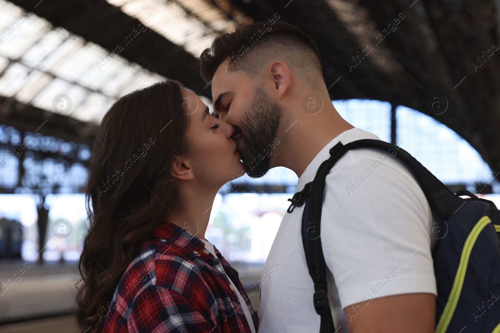 Photo of Long-distance relationship. Beautiful couple kissing on platform of railway station