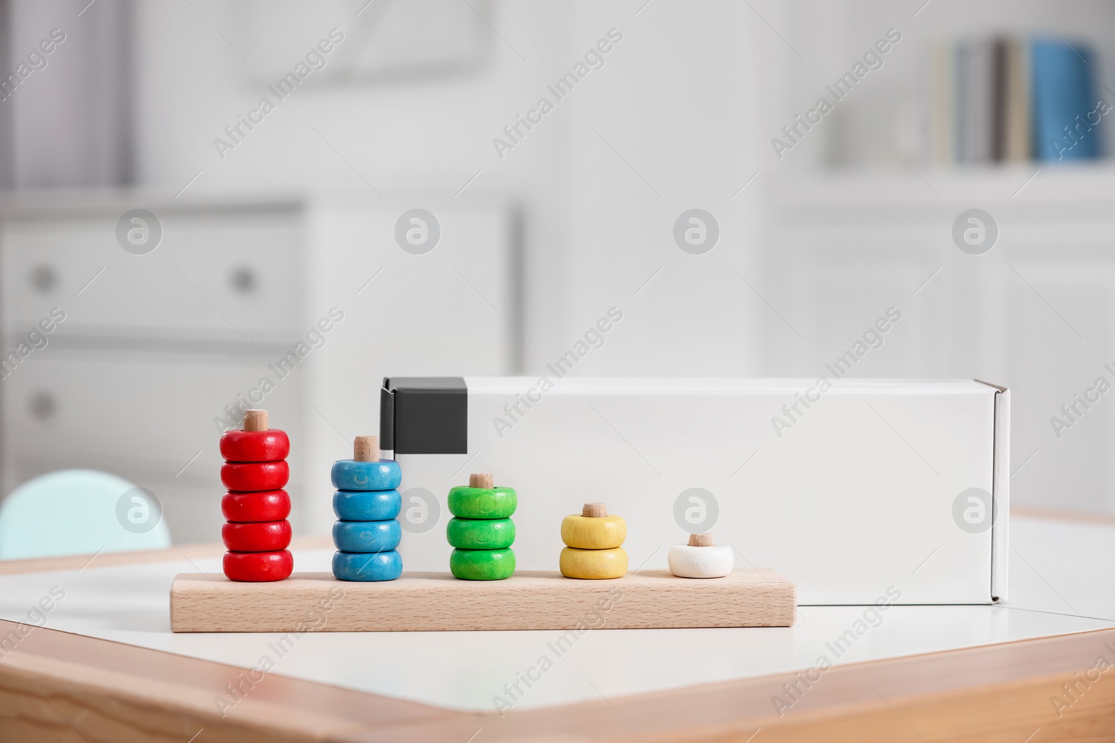 Photo of Stacking and counting game wooden pieces on table indoors, space for text. Educational toy for motor skills development