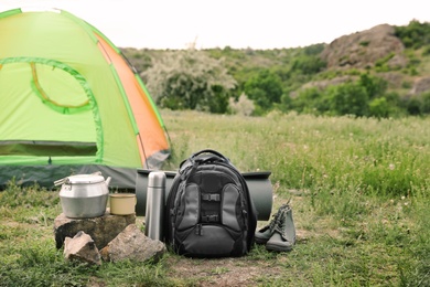 Photo of Camping gear and tourist tent in wilderness