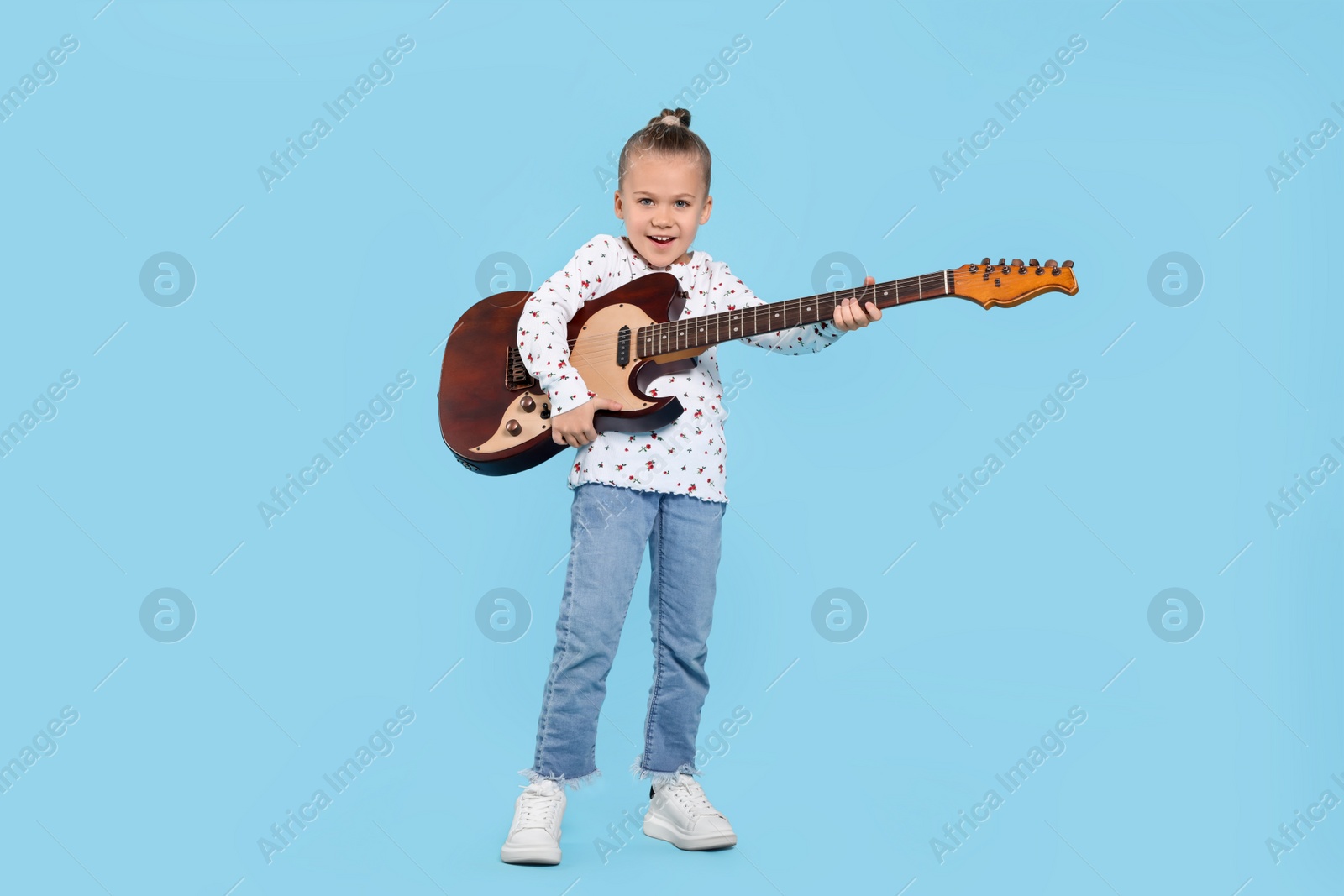 Photo of Happy girl with electric guitar on turquoise background