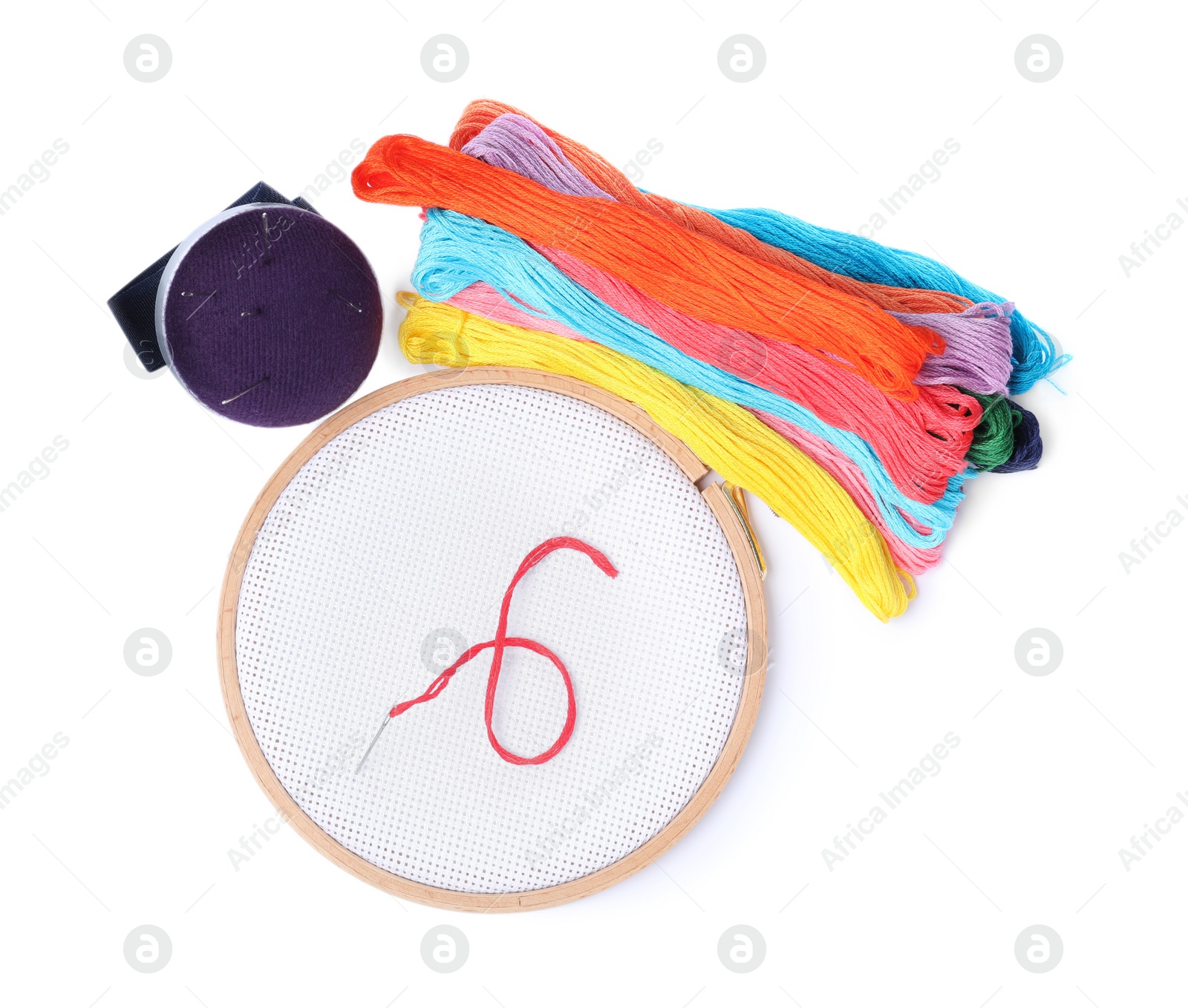 Photo of Colorful threads and different embroidery accessories on white background, top view